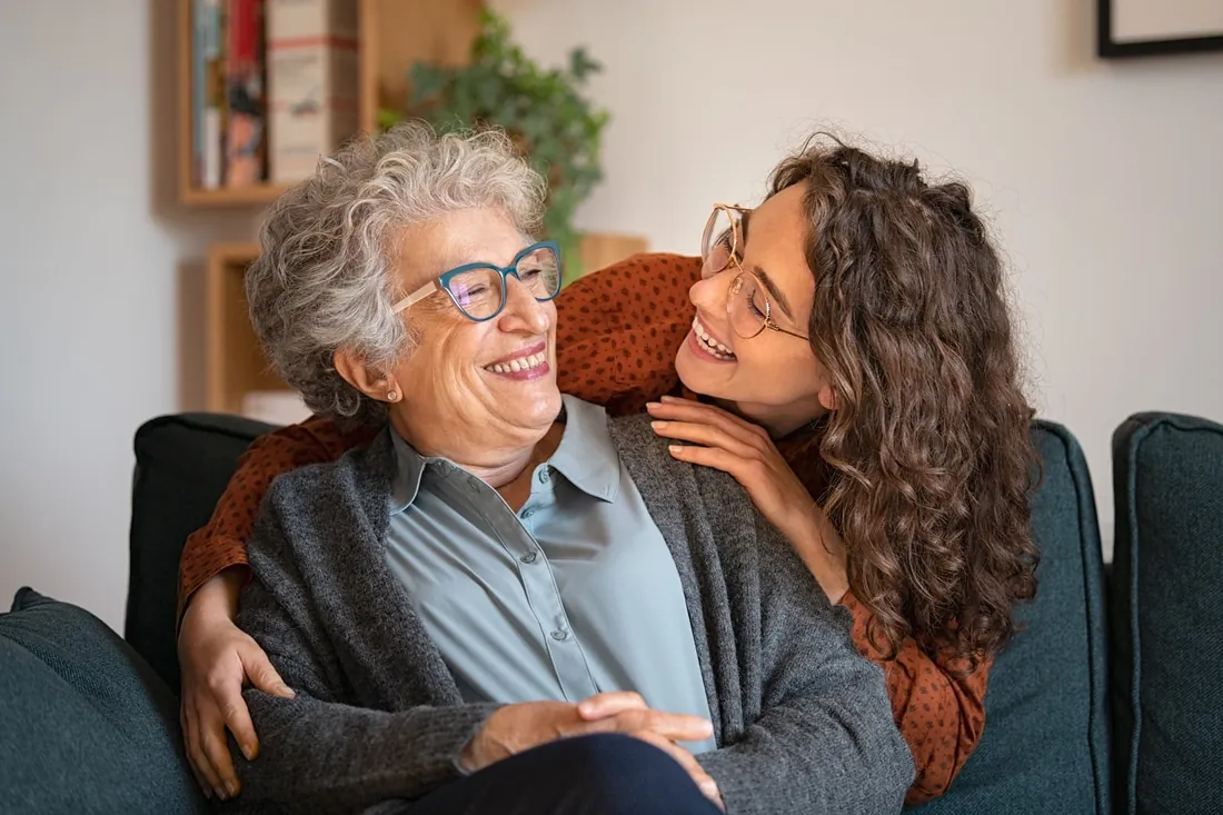 Patient smiling with family after implant treatment